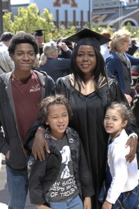 Stellner poses in cap and gown with her three children